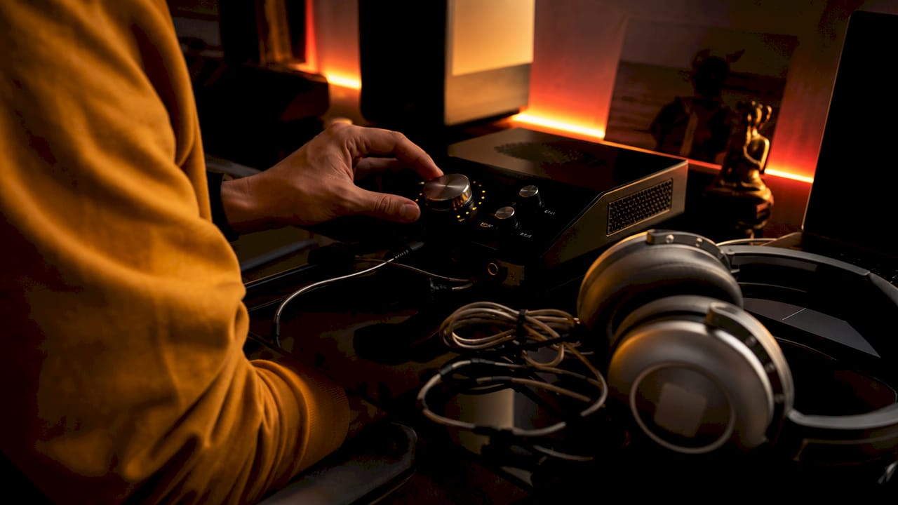 Hands adjusting binaural audio equipment