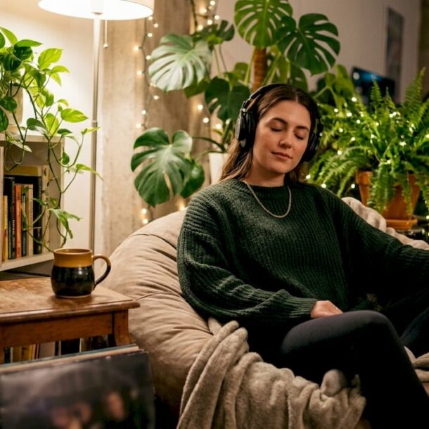 Woman listening to music in cozy nighttime apartment