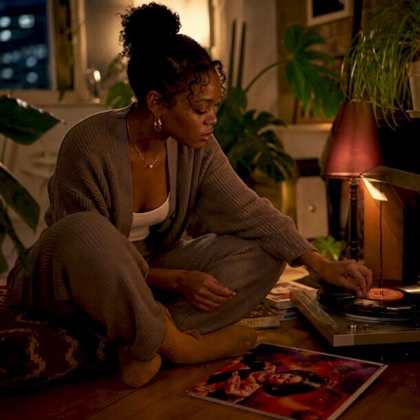 Woman adjusting turntable for late-night music