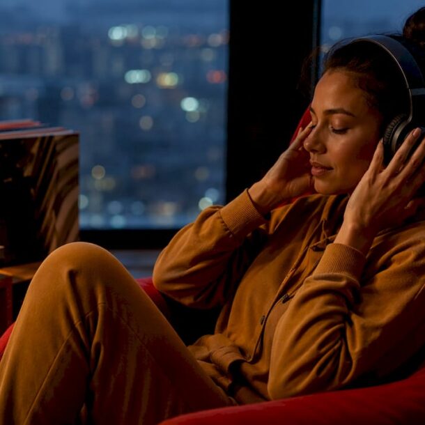 Woman enjoying calm music at home in evening